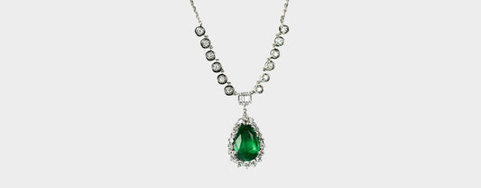 Radiance Redefined: The Stunning 5 Carat Pear Emerald and Diamond Masterpiece