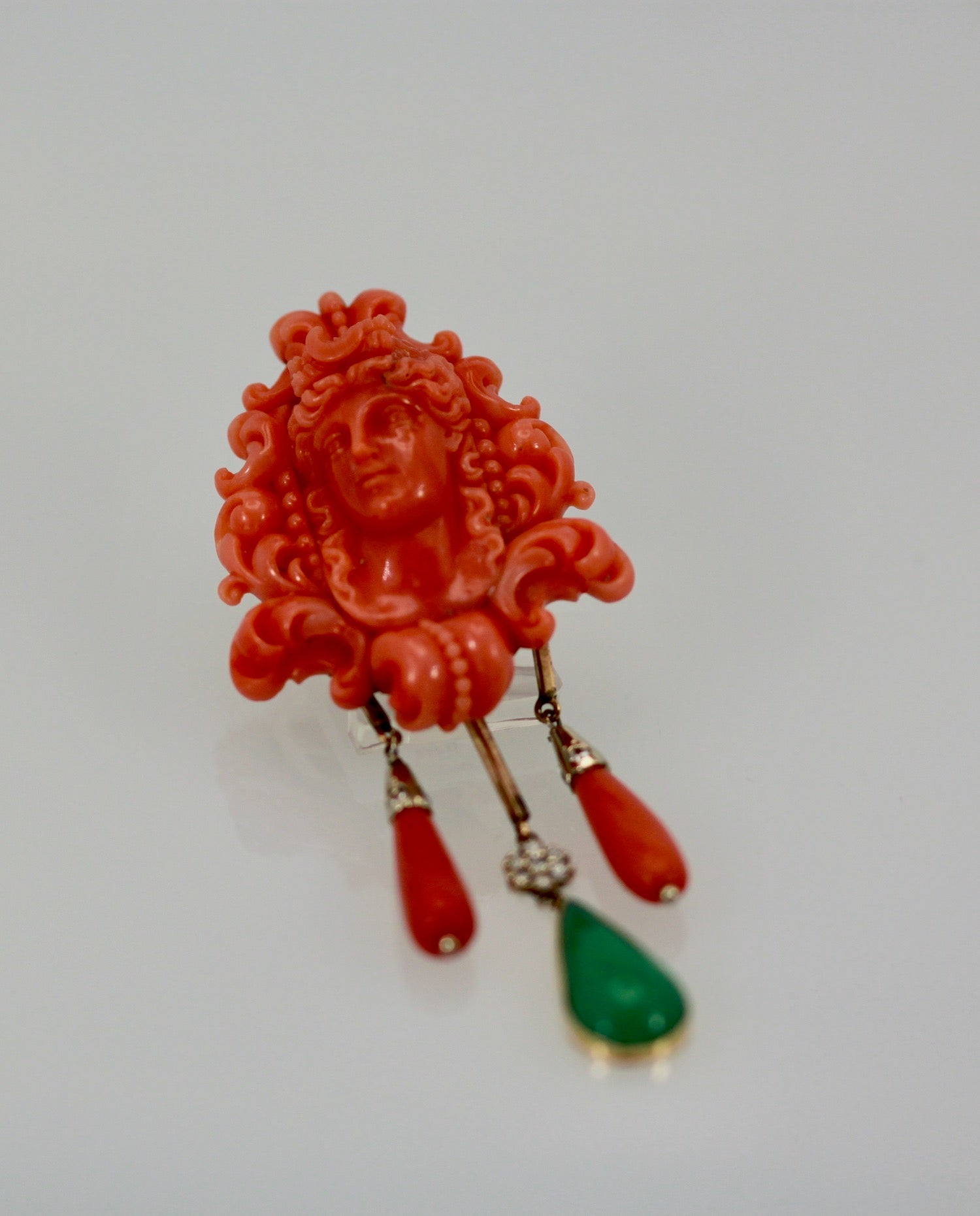 Coral drop brooch with green stone