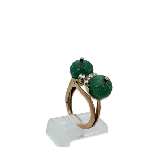 Diamond ring with carved emeralds