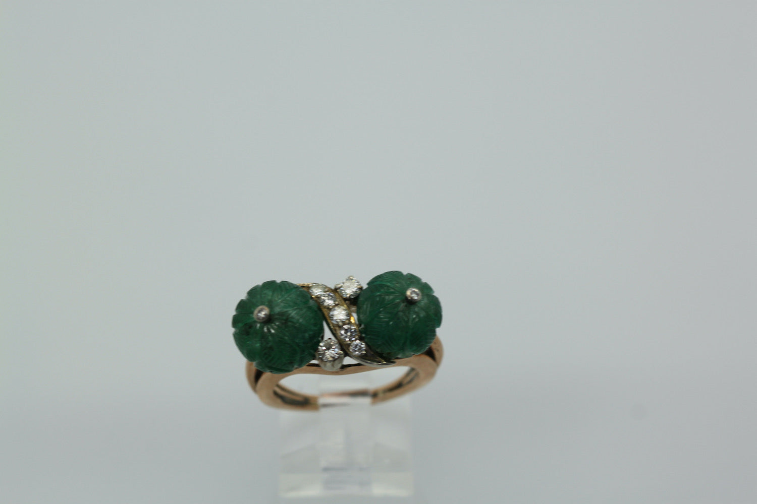 Diamond ring with carved emeralds