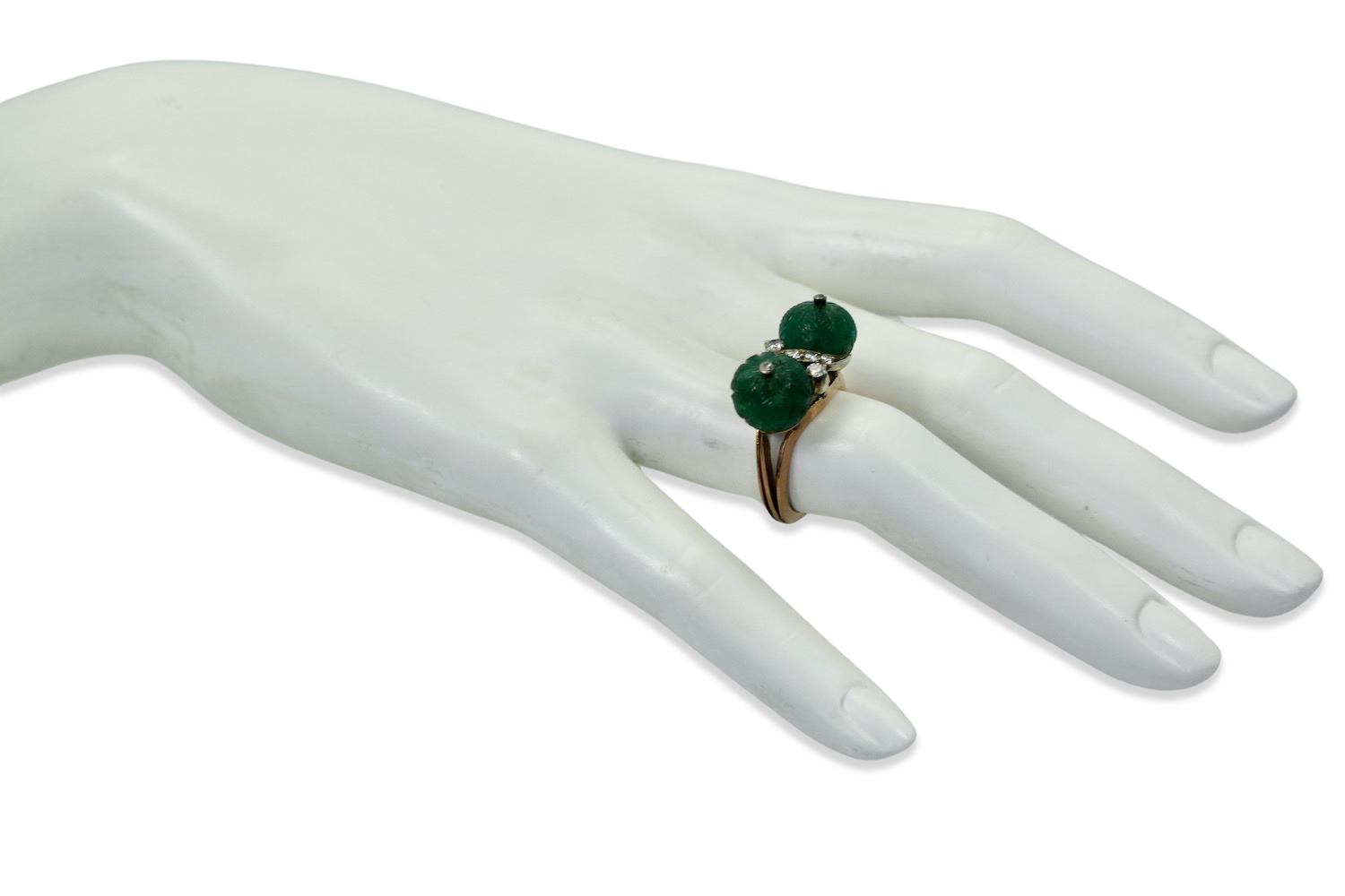 Diamond ring with carved emeralds