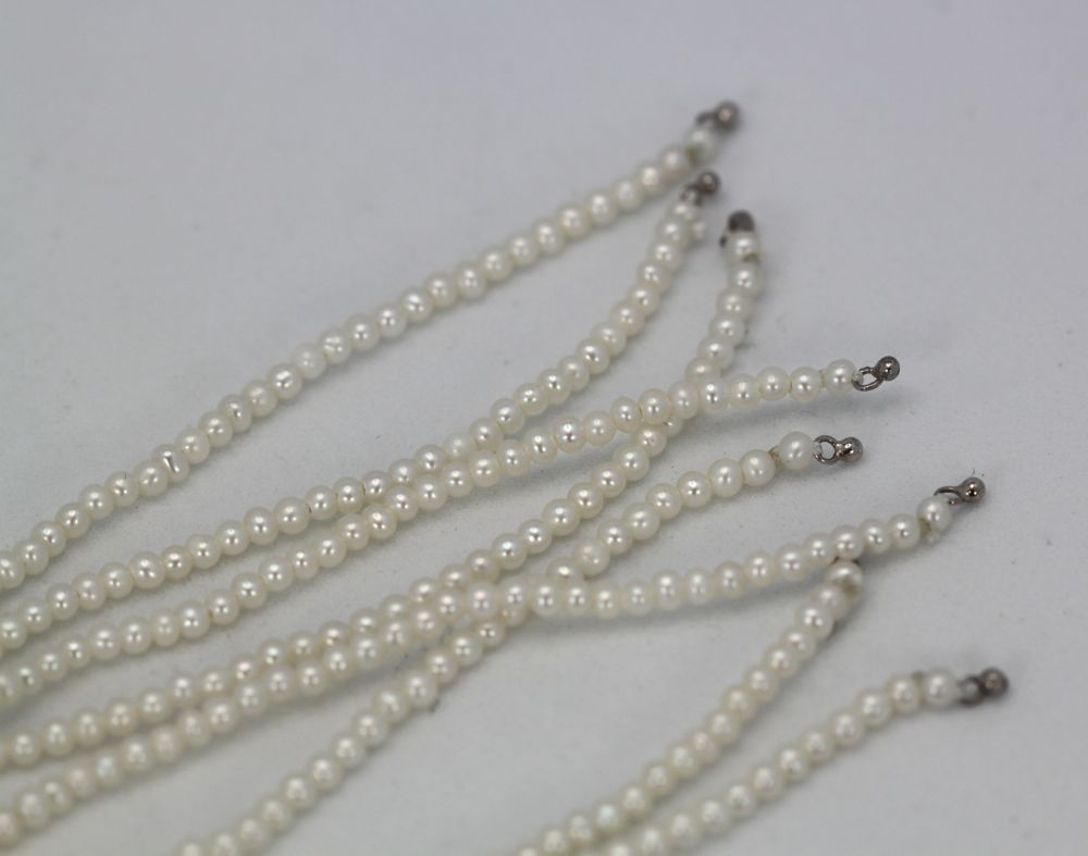 Multiple strands of pearls on a light
