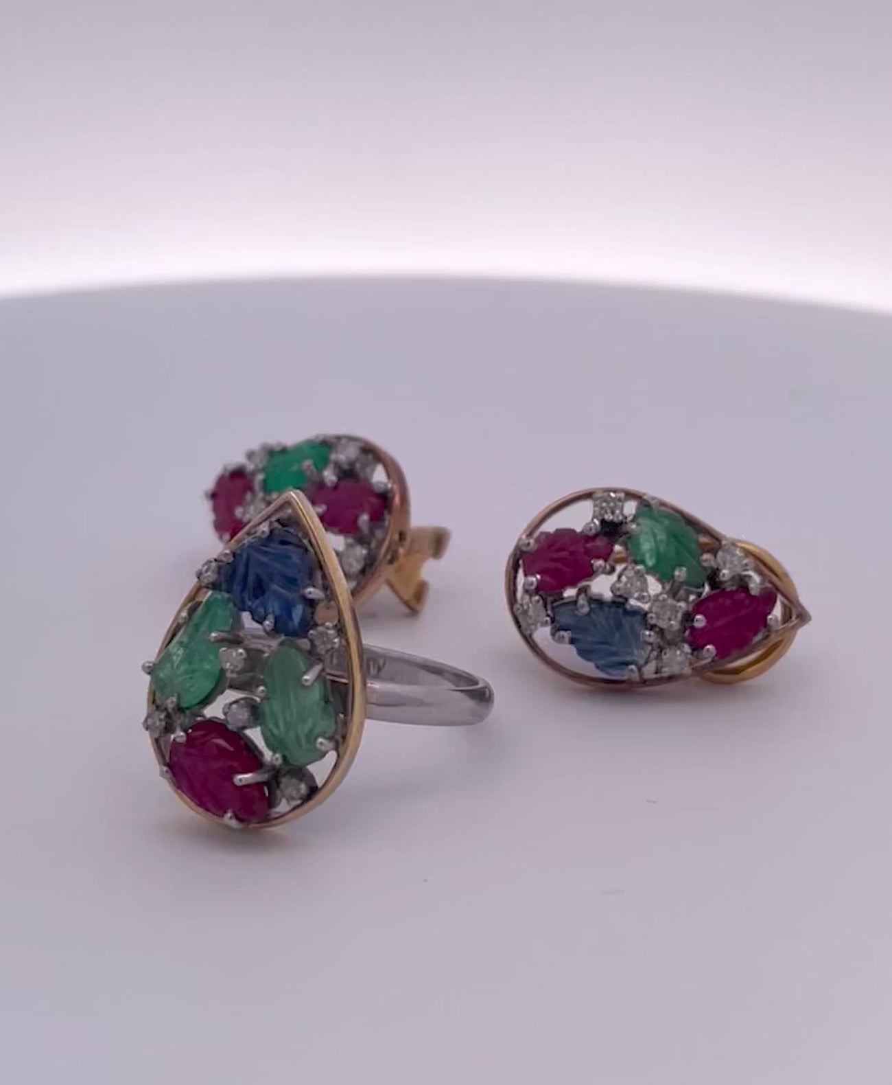 Colorful carved gemstone set with diamonds